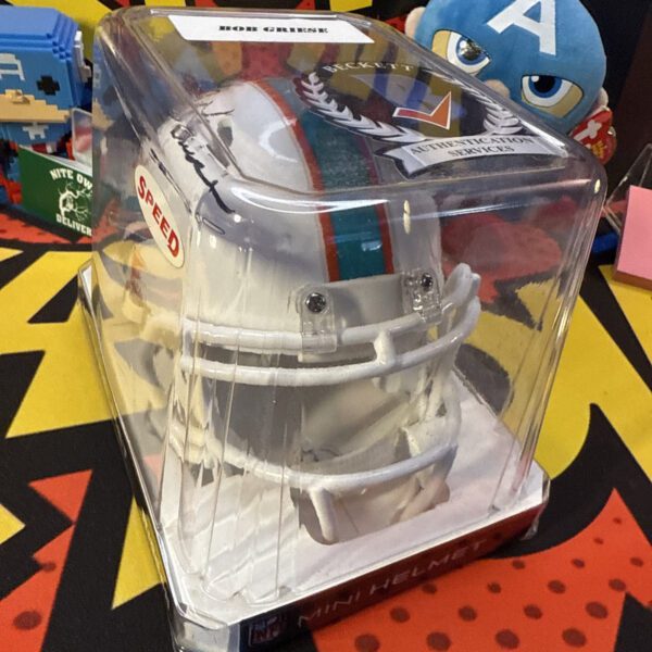 A white sneaker sitting in a box on top of a table.